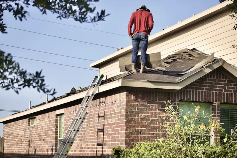 Professional roofer working on a residential roof in Posen